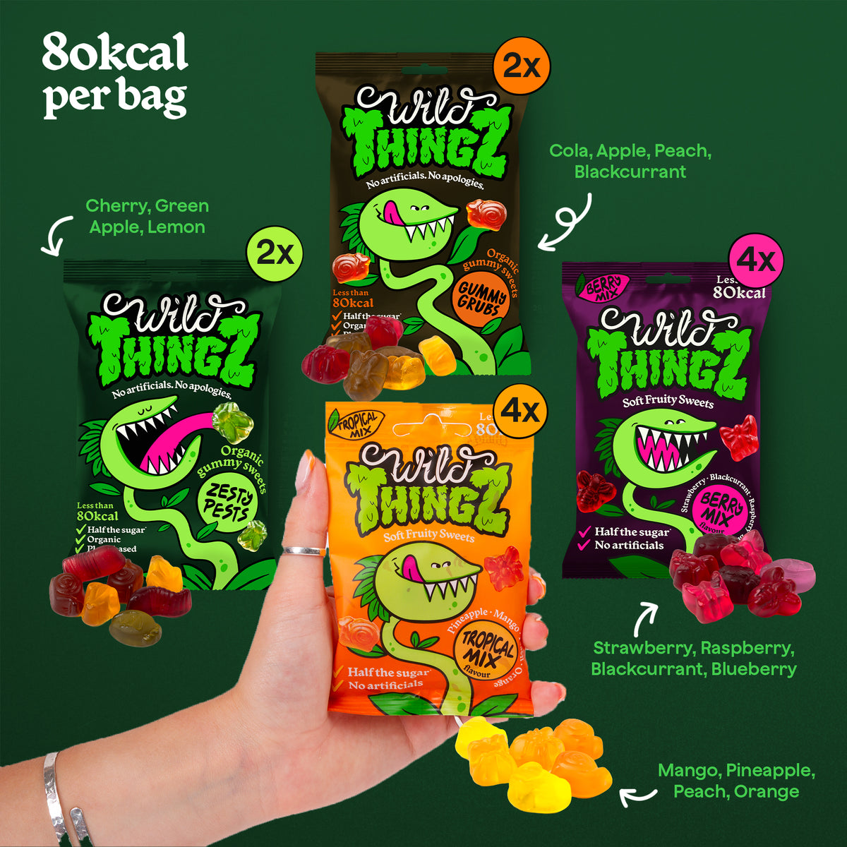 Hand holding a Tropical Mix bag among Zesty Pests, Gummy Grubs and Berry Mix bags, with the fruit flavours of each listed, 80kcal per bag